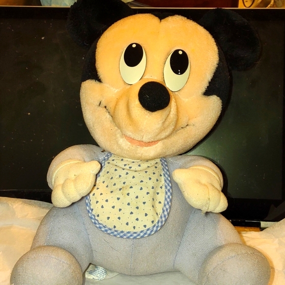 Adorable baby Mickey Mouse with blue bib